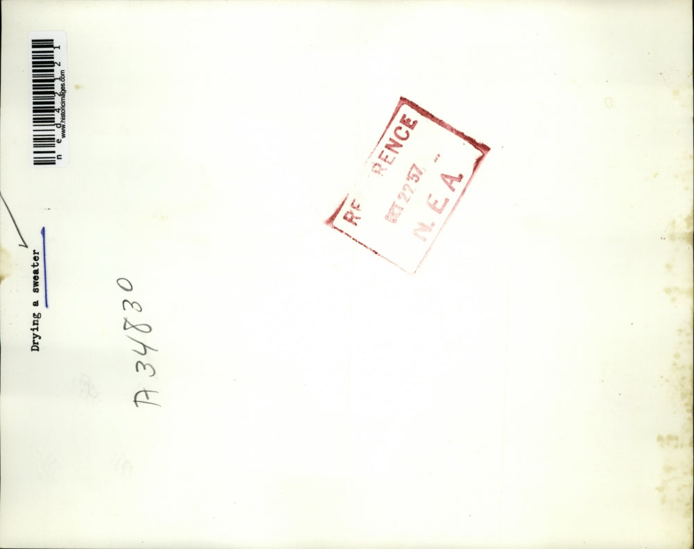 1957 Press Photo Drying a sweater