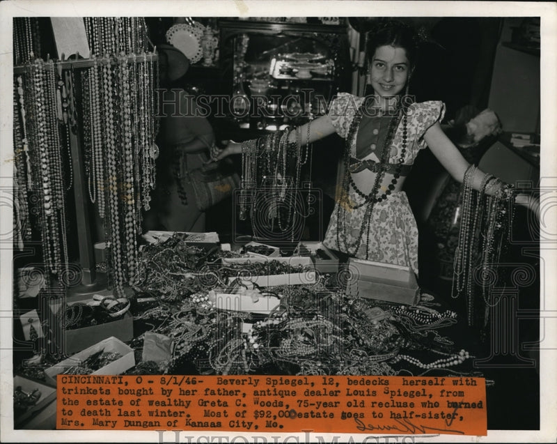 Load image into Gallery viewer, 1946 Press Photo Beverly Spiegel, 12, bedecks herself with trinkets bought by

