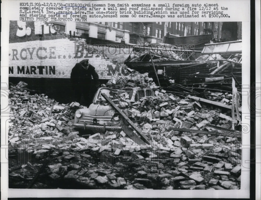 1956 Press Photo Don Smith Examines Collapsed Foreign Auto Shop