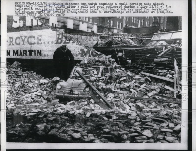 Load image into Gallery viewer, 1956 Press Photo Don Smith Examines Collapsed Foreign Auto Shop
