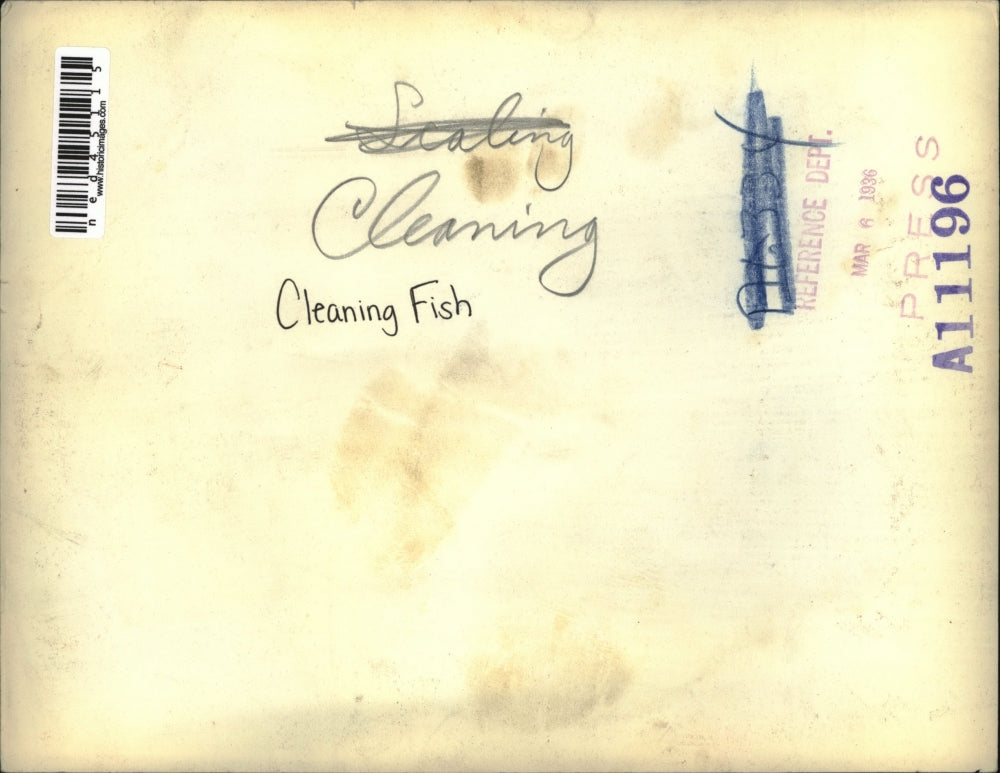 1936 Press Photo Man Cleaning Fish