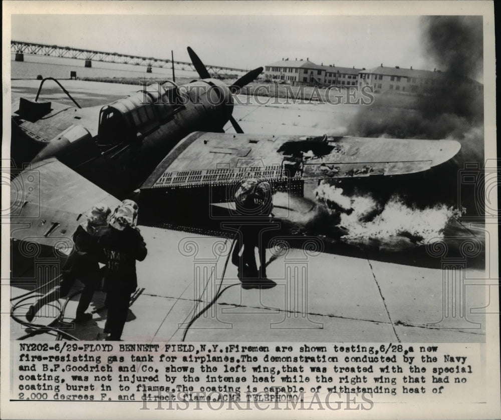 1949 Press Photo Firemen are shown testing a new fire resisting gas tank for