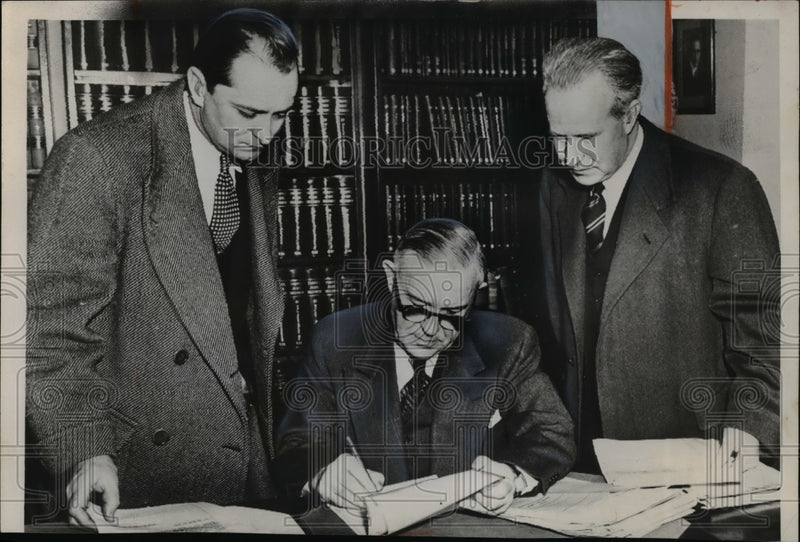 Load image into Gallery viewer, 1953 Press Photo Benjamin Schreiber as he signs an order
