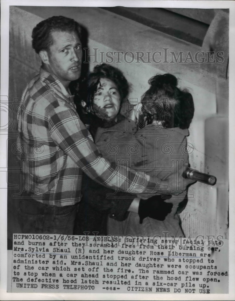Load image into Gallery viewer, 1956 Press Photo LA Calif Mrs Sylvia Shaul daughter Rose aided after car fire
