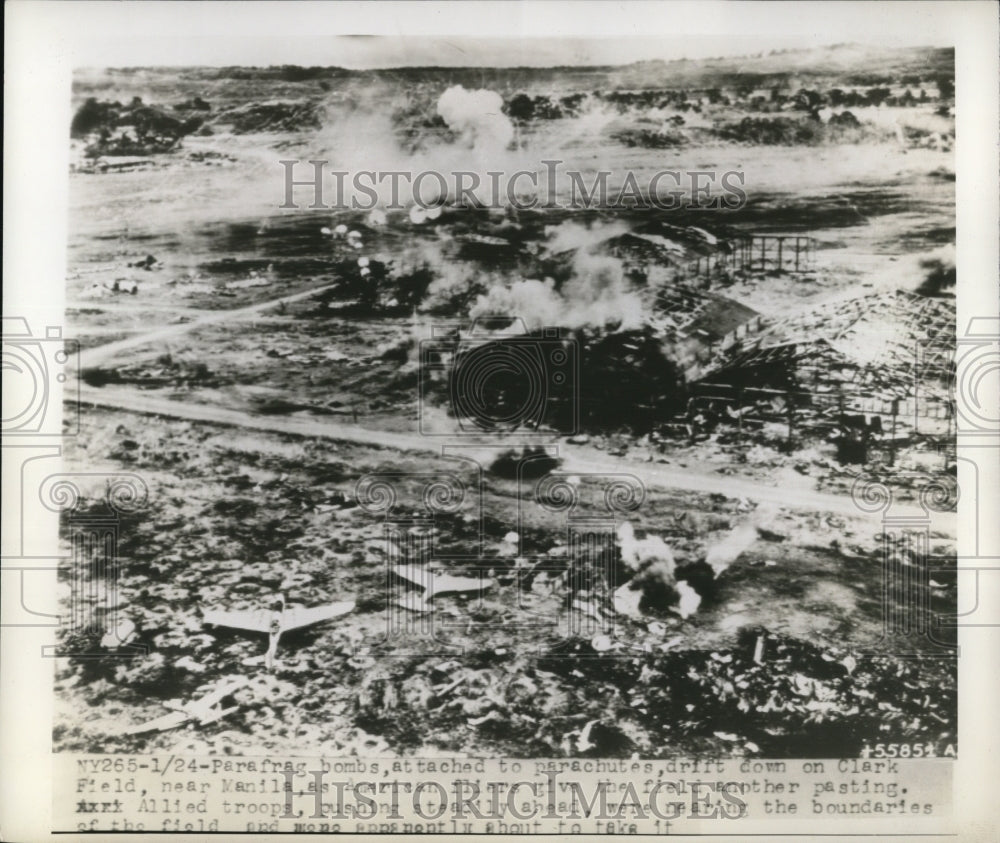 1945 Press Photo para frag bombs attached to parachutes drift down on Clark
