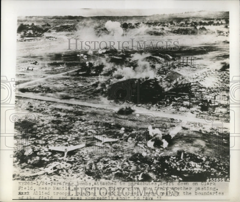 Load image into Gallery viewer, 1945 Press Photo para frag bombs attached to parachutes drift down on Clark
