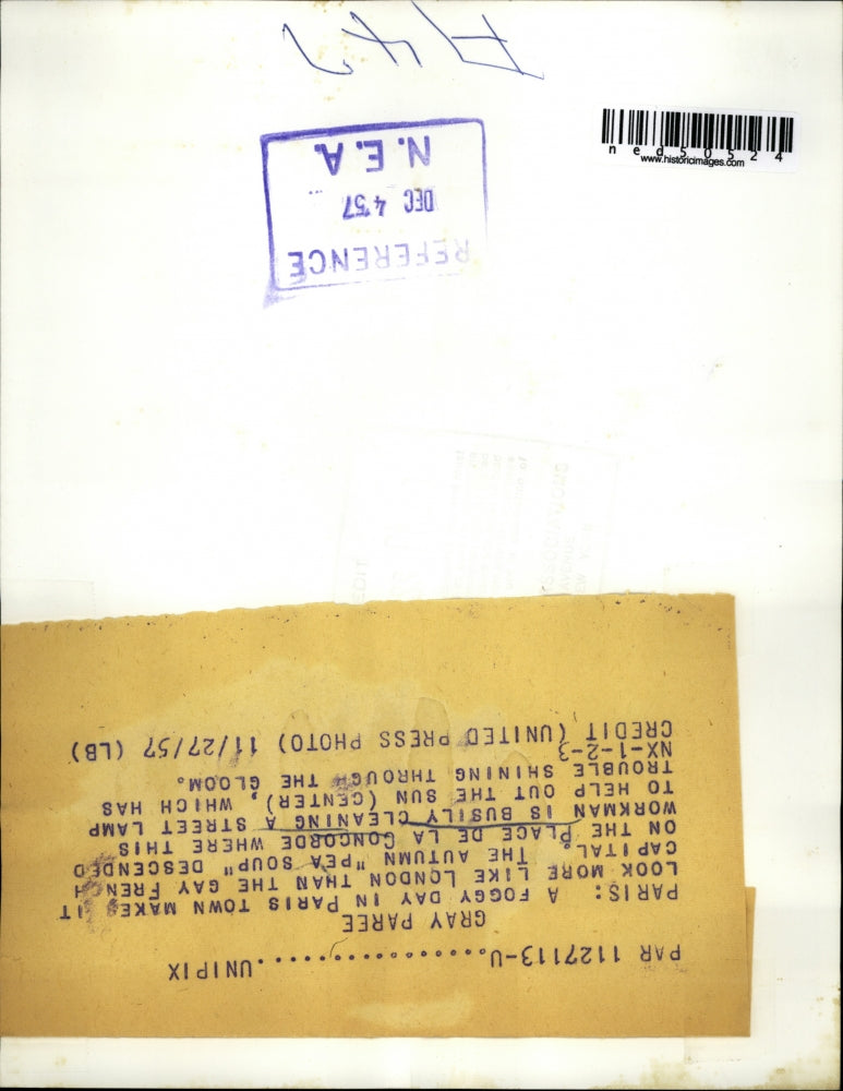 1957 Press Photo Paris a workman is cleaning a street lamp on the Place De La