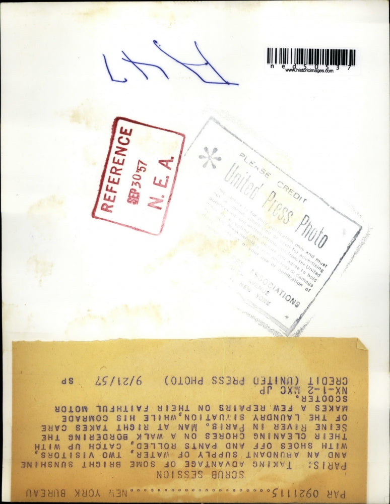 1957 Press Photo Man Cleaning Clothes on Seine River in Paris