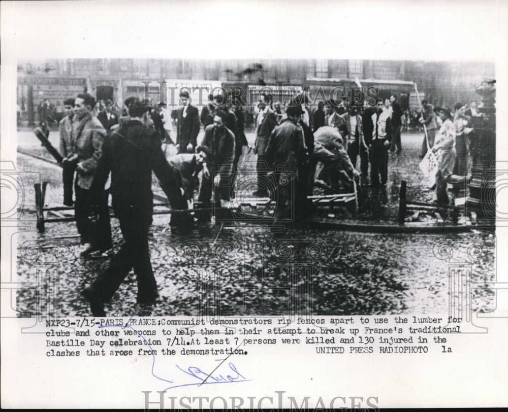 1953 Press Photo Communist Demonstrators Destroy Fences for Weapons, Paris