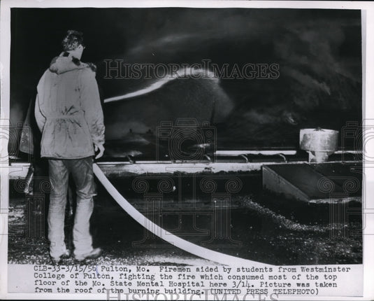 1956 Press Photo Fireman aided by student fighting fire MO State Mental Hospital