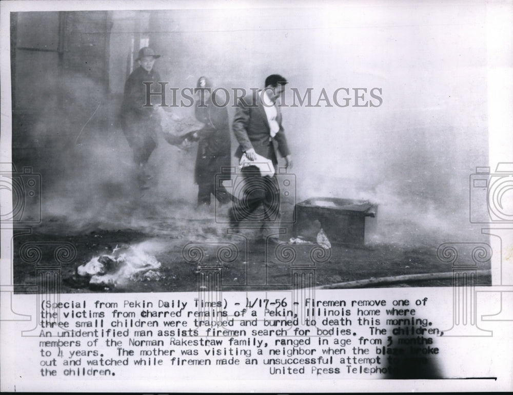 1956 Press Photo Fireman remove victims charred remains of a Pekin IL home