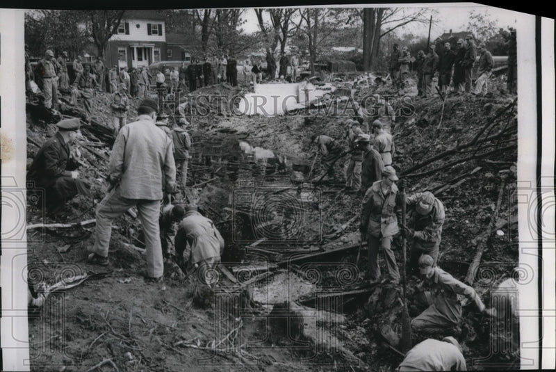 Load image into Gallery viewer, 1958 Press Photo Salvage workers from Selfridge Air Force Base dig in the mud.
