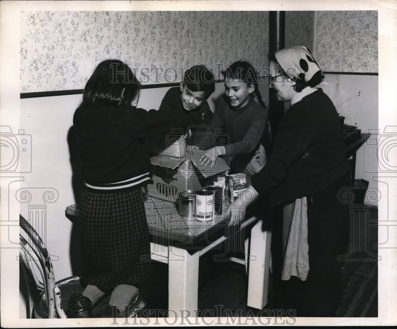 Load image into Gallery viewer, 1955 Press Photo Viennese Widow Receives CARE Food Crusade Package

