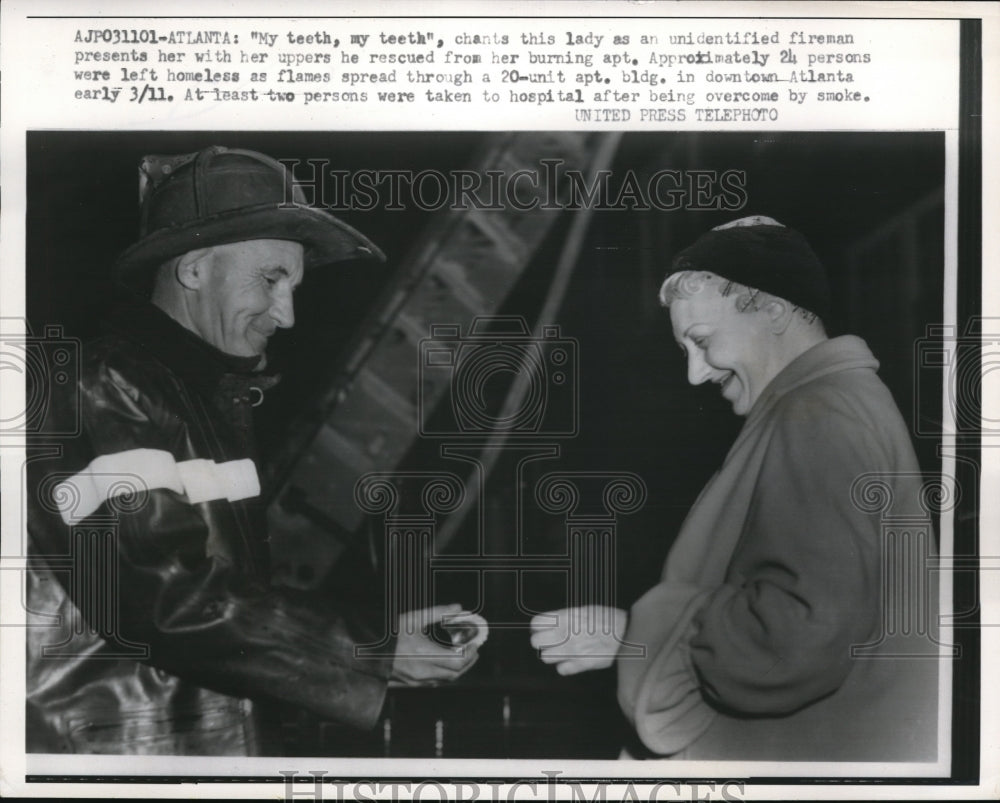 1958 Press Photo Lady chants w/ an unidentified fireman