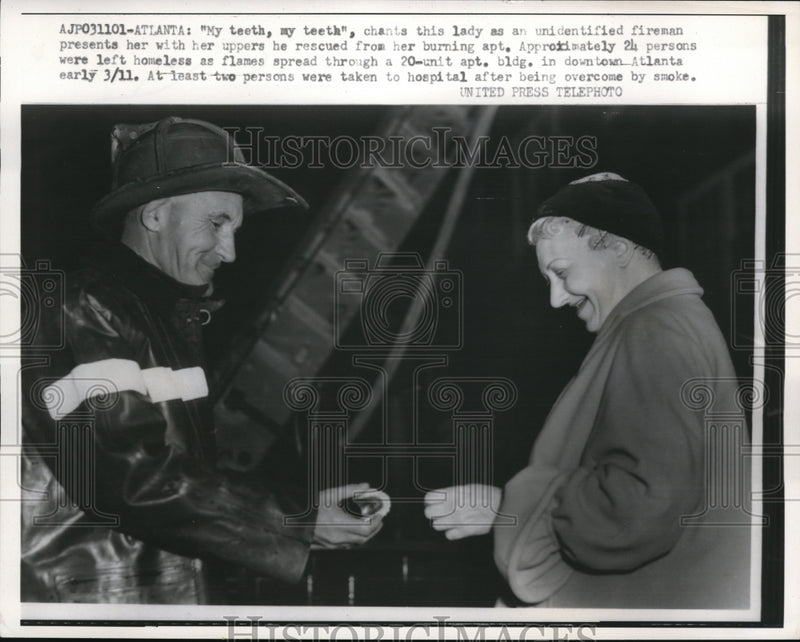 Load image into Gallery viewer, 1958 Press Photo Lady chants w/ an unidentified fireman
