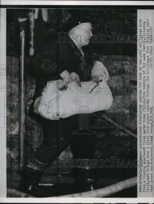 1952 Press Photo A firefighter carries the body of two year old Carole Horn