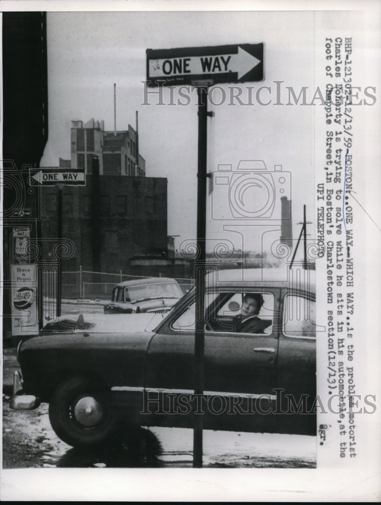 1959 Press Photo Charles Doherty as he sits in his automobile at Chappie Street