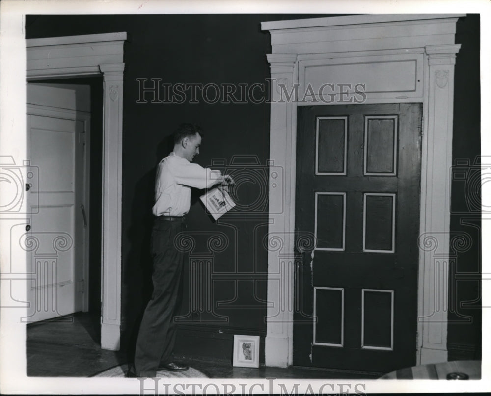 1951 Press Photo A man decorating the interior of a house