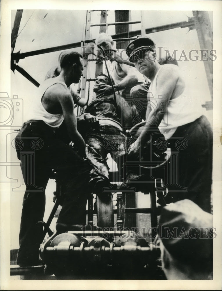 1938 Press Photo Firemen shown lowering unconscious Sidney Stein after accident