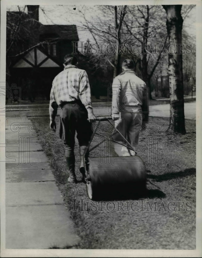 Load image into Gallery viewer, 1947 Press Photo Kenneth Bier and Dick Adler roll the lawn

