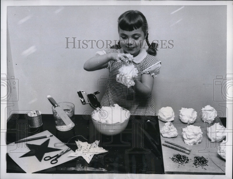 Load image into Gallery viewer, 1956 Press Photo Little girl making snowball yule decoration from soap powder
