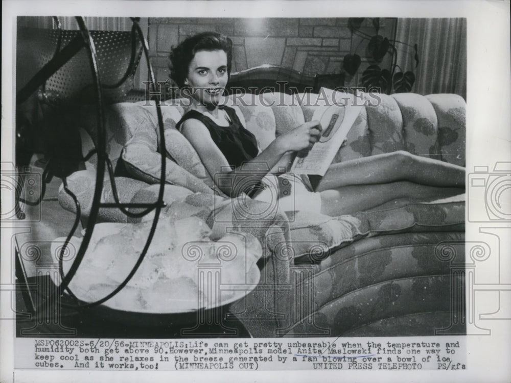 1956 Press Photo Anita Maslowski, Minn. Model relaxed by a fan blowing with ice