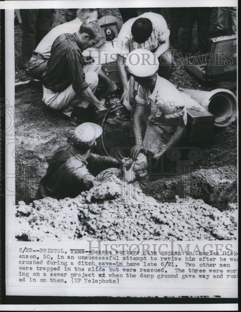 1956 Press Photo Rescue Workers give oxygen to Charles Dickinson, 50