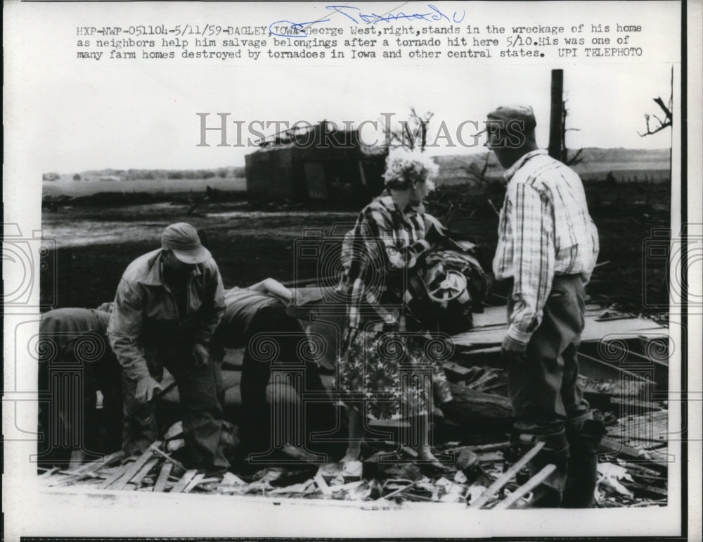 1959 Press Photo George West (R) stands in the wreckage of his home