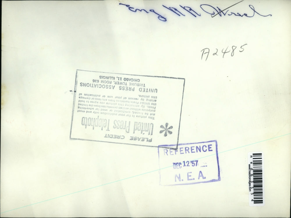 1957 Press Photo Firemen and a civil motorcyclist use a pole to help a victim