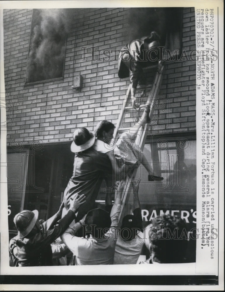 1957 Press Photo North Adams Mass Mrs Lillian Forbush rescued from a fire