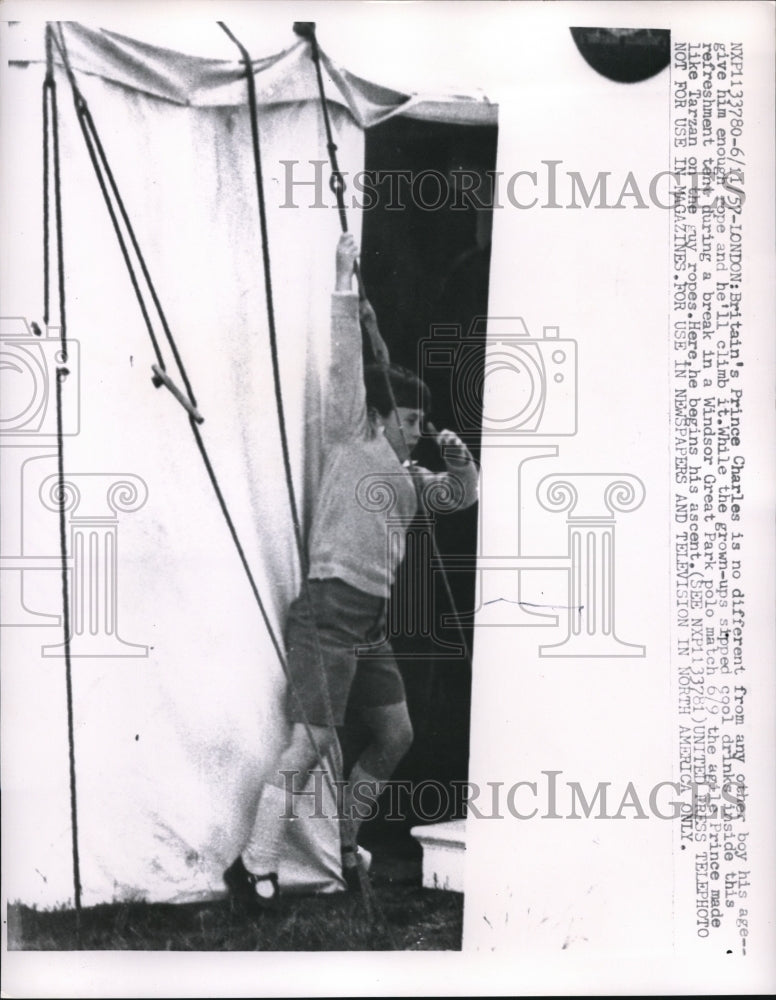 1957 Press Photo Prince Charles Climbing while at Windsor Great Park Polo Match- Historic Images