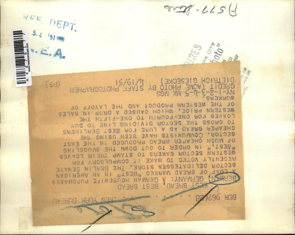 1951 Press Photo German housewife purchases a loaf of bread marked as West