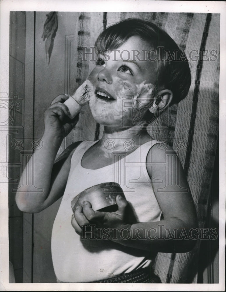 1953 Press Photo Michael Collingridge uses his father shaving equipment.