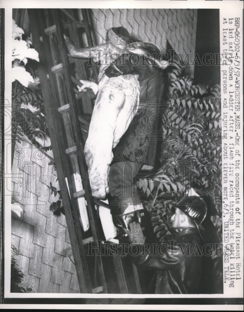 Load image into Gallery viewer, 1957 Press Photo Occupant of Pleasant Hotel led safely down a ladder during fire
