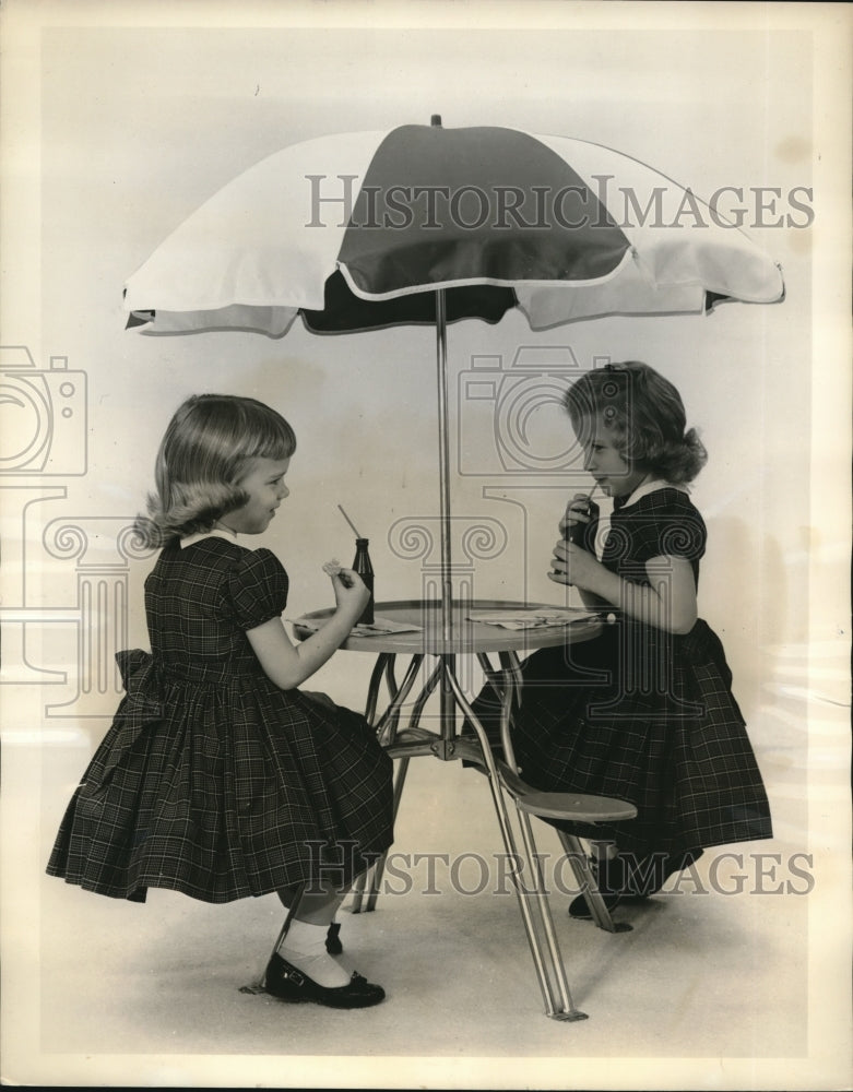 1960 Press Photo Umbrella topped party table by Kusan Inc is welcome equipment