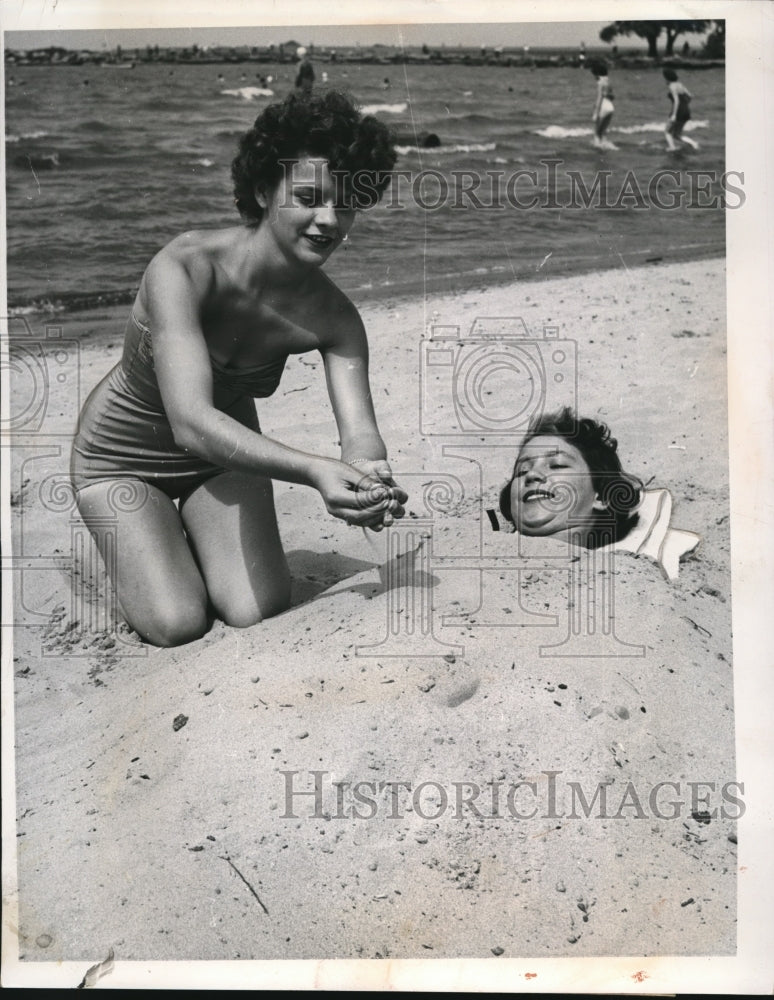 1953 Press Photo Miss Millie Spiroch buried by Miss Rosemarie Krmpotich