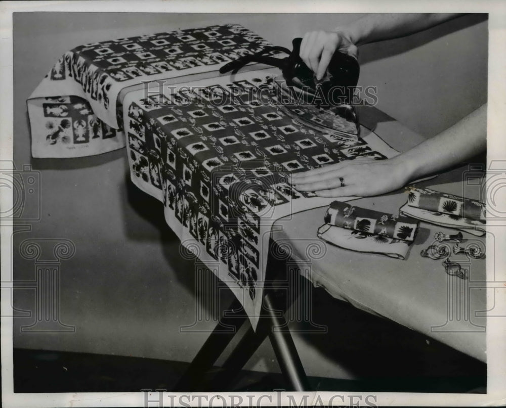 1953 Press Photo Homemaker using a iron to press hankies