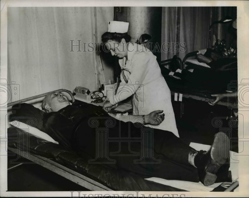 Load image into Gallery viewer, 1943 Press Photo Karl Miller Giving Blood at Red Cross Blood Bank
