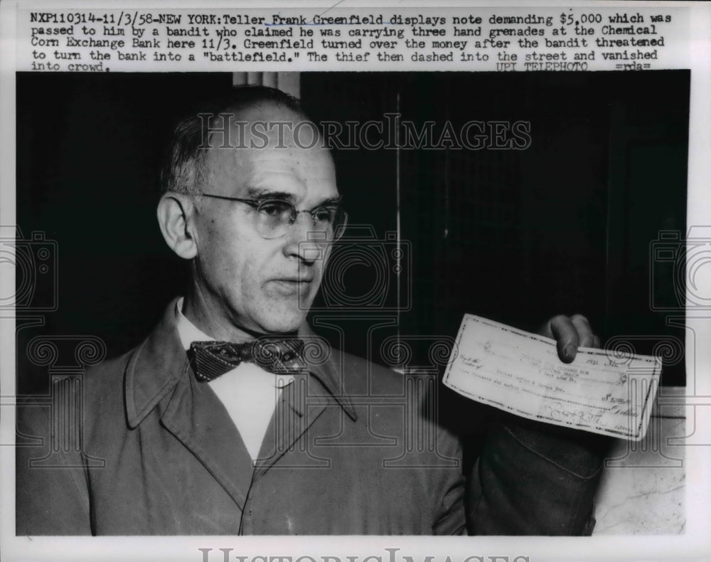 1958 Press Photo Bank teller, Frank Greenfield displays the note from a bandit