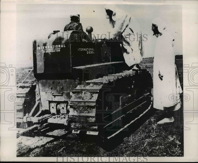 Load image into Gallery viewer, 1950 Press Photo Arabs make acquantance in farming methods of Diesel Tractor.

