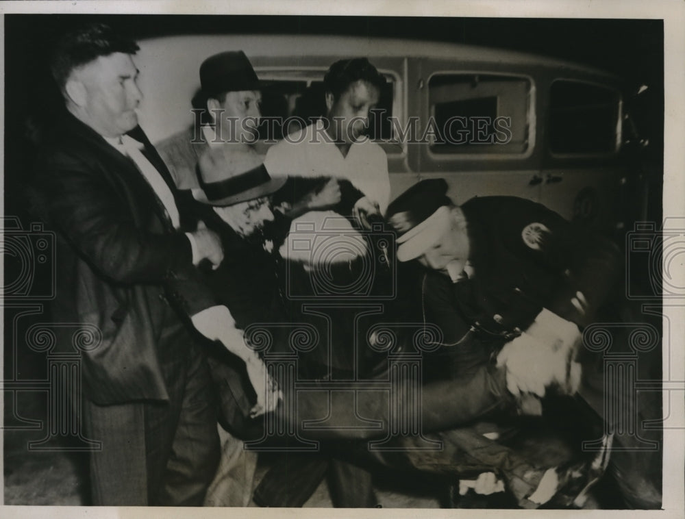 1935 Press Photo An Iron Works striker was placed in an ambulance after the riot