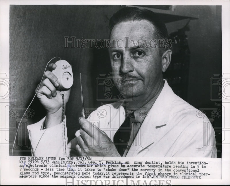 Load image into Gallery viewer, 1954 Press Photo Geo Perkins Holding his Electronic Clinical Thermometer
