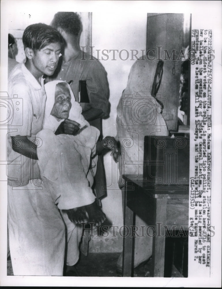 Load image into Gallery viewer, 1962 Press Photo Madame Kahirodsundari, 105-years-old carried by grandson
