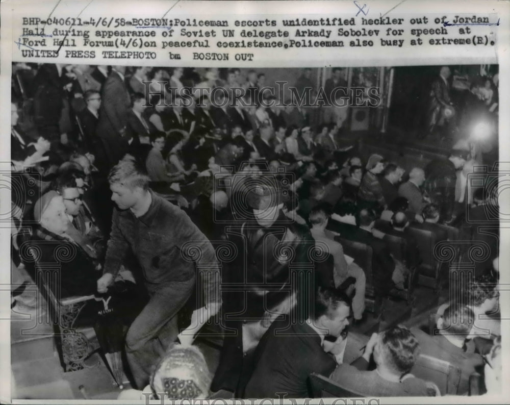 1958 Press Photo Policeman Escorts Unknown Heckler Out Of Jordan Hall- Historic Images