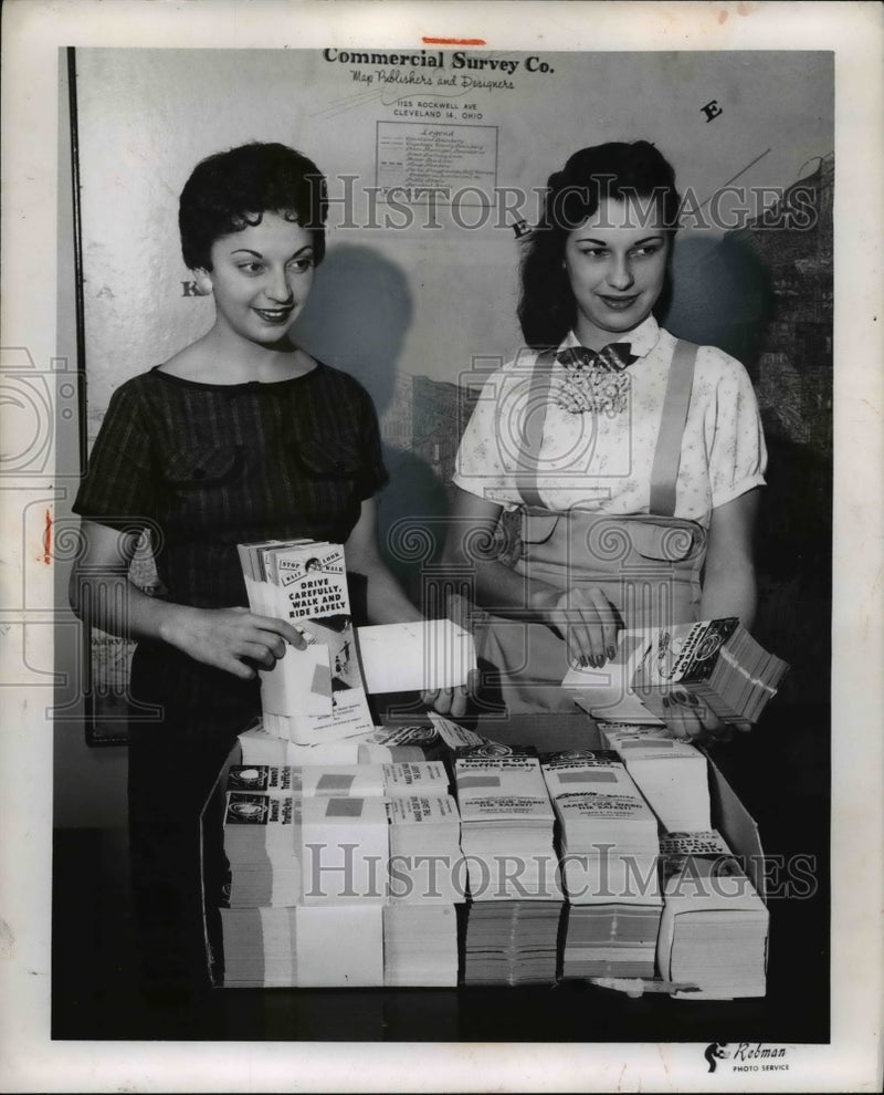 Load image into Gallery viewer, 1957 Press Photo Nilda Trinetti and Mrs. Annette Guenthii holding brochures
