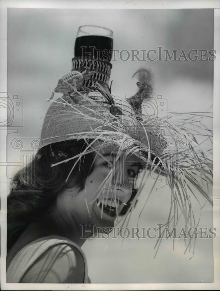 Load image into Gallery viewer, 1956 Press Photo of Jo Tapley wearing a fringed beach hat.

