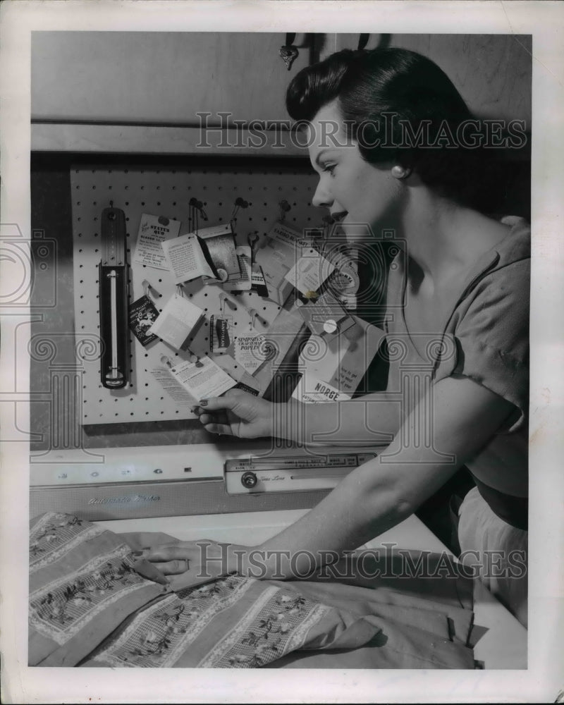 1955 Press Photo Tags tell the tale of Washing