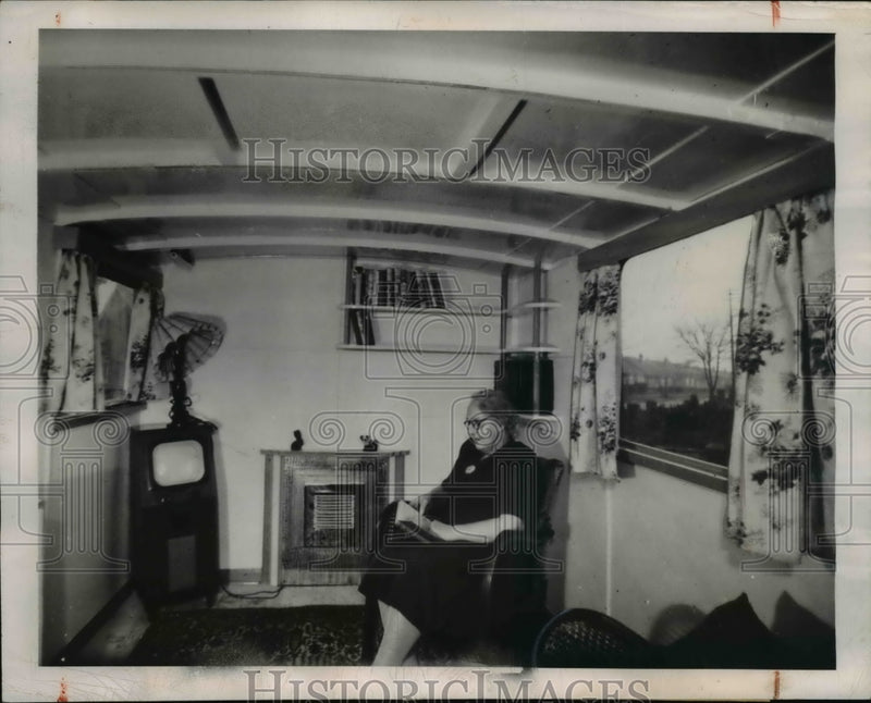 Load image into Gallery viewer, 1949 Press Photo of woman sitting in one of five rooms in house that was fomerly
