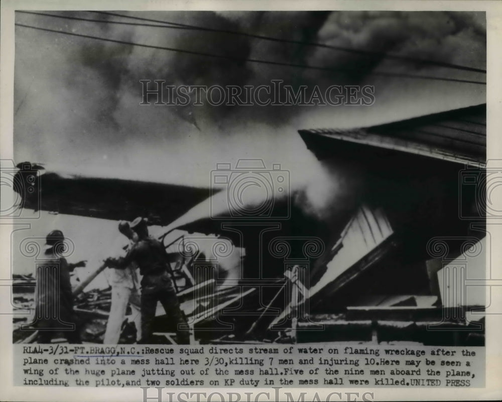 1954 Press Photo of firemen battling a fire that was caused by plane crashing