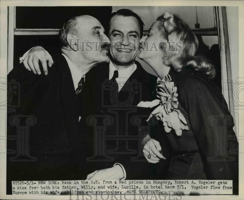 Load image into Gallery viewer, 1951 Press Photo of Robert A. Vogler receiving a kiss from his wife and his
